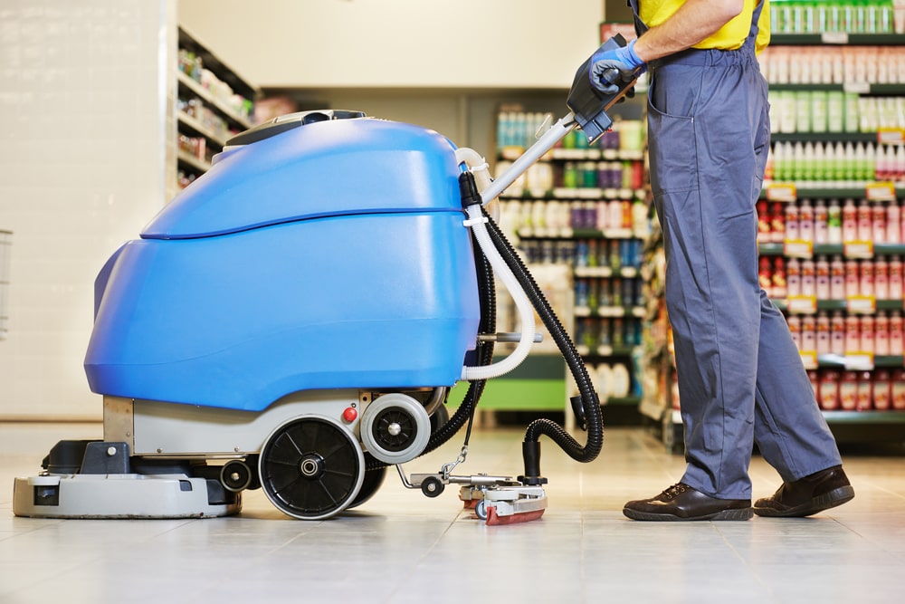a cordless electriacally powered floor machine being used in a grocery store.