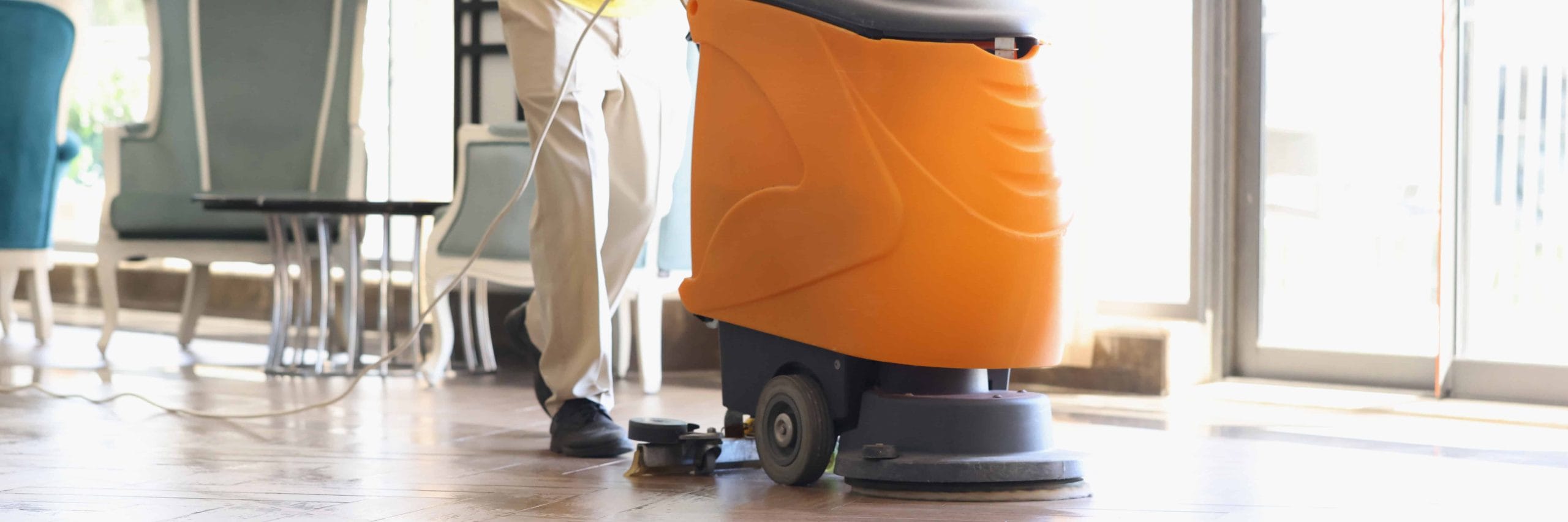 Man cleaning huge lobby with industrial vacuum cleaner